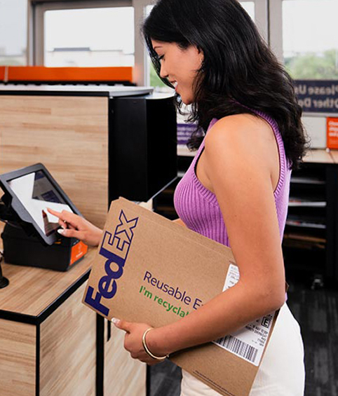 FedEx self-service kiosk showing 'Scan the QR Code using scanner below' — the screen customers will see when they drop off documents